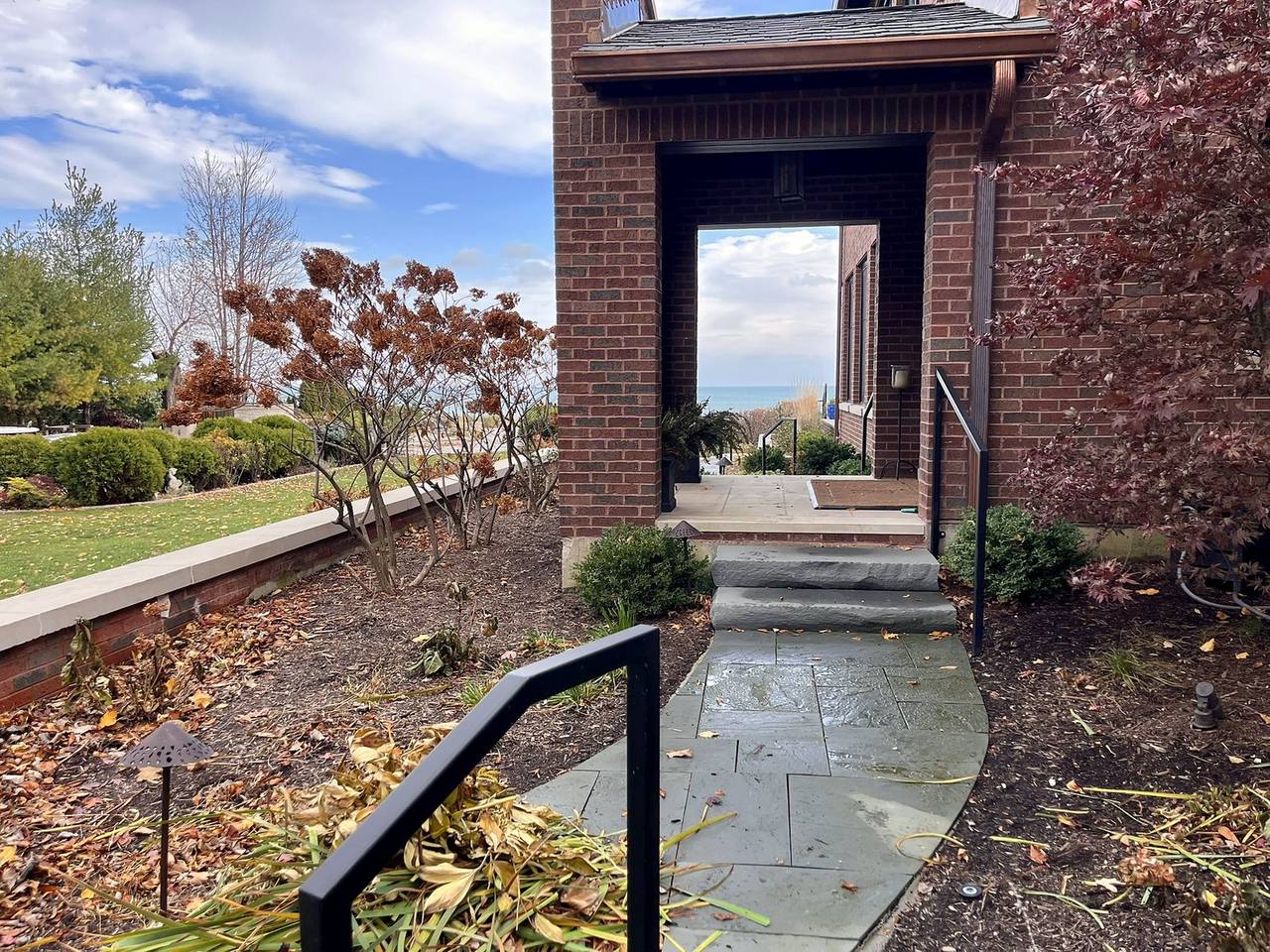 Bluestone walk through a brick gateway framing the lake